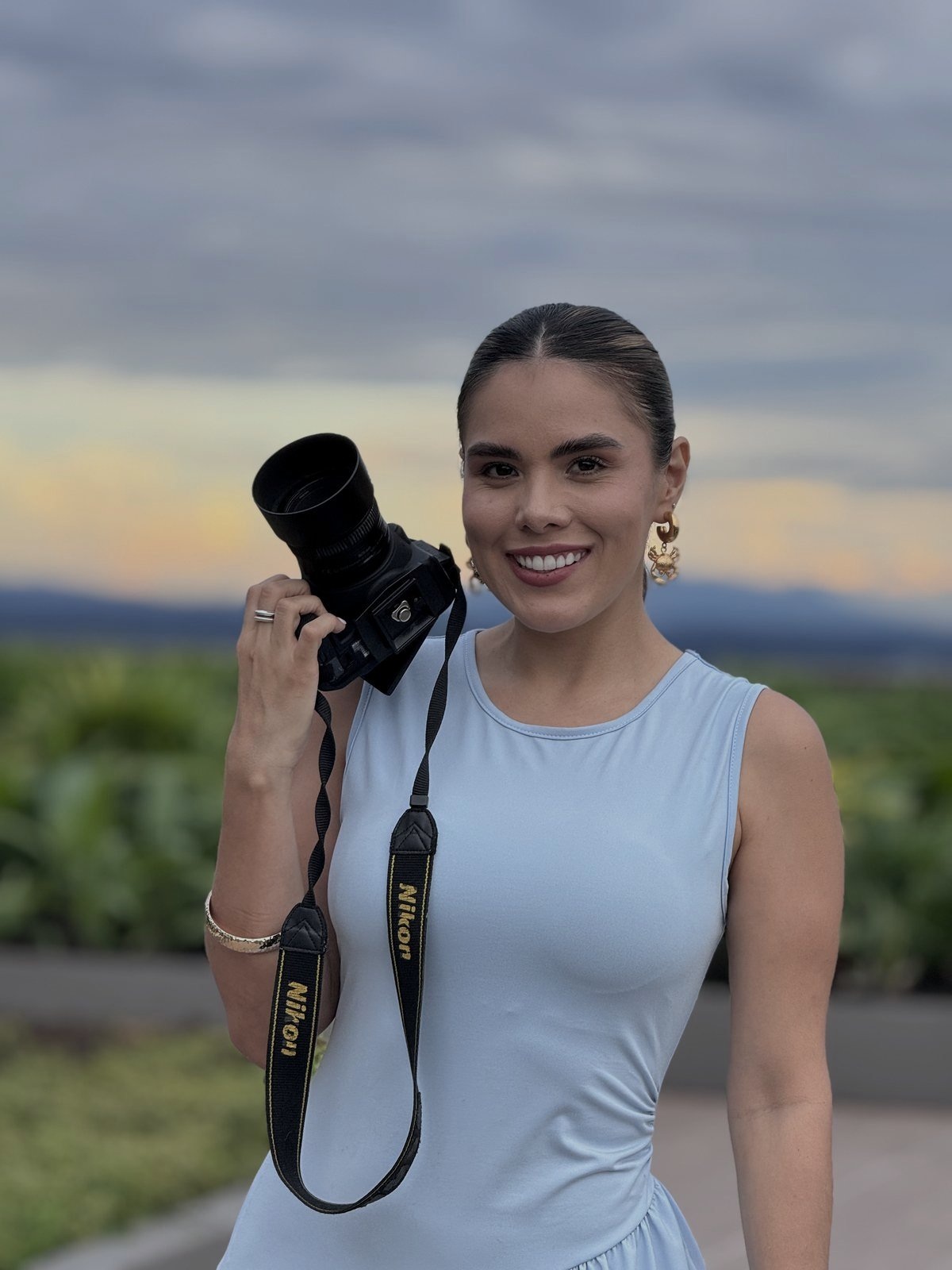 Tatiana Márquez sosteniendo una cámara en un paisaje